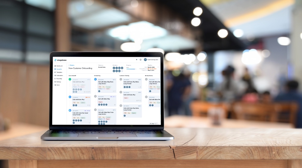 Laptop on a table showing the Stagebase new-customer onboarding board.